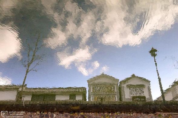 In the Bikan historical quarter of Kurashiki in Okayama Prefecture, Japan, Edo-era storehouses are being reflected off of the surface of a canal. © 2012 Norbert Woehnl Photography.