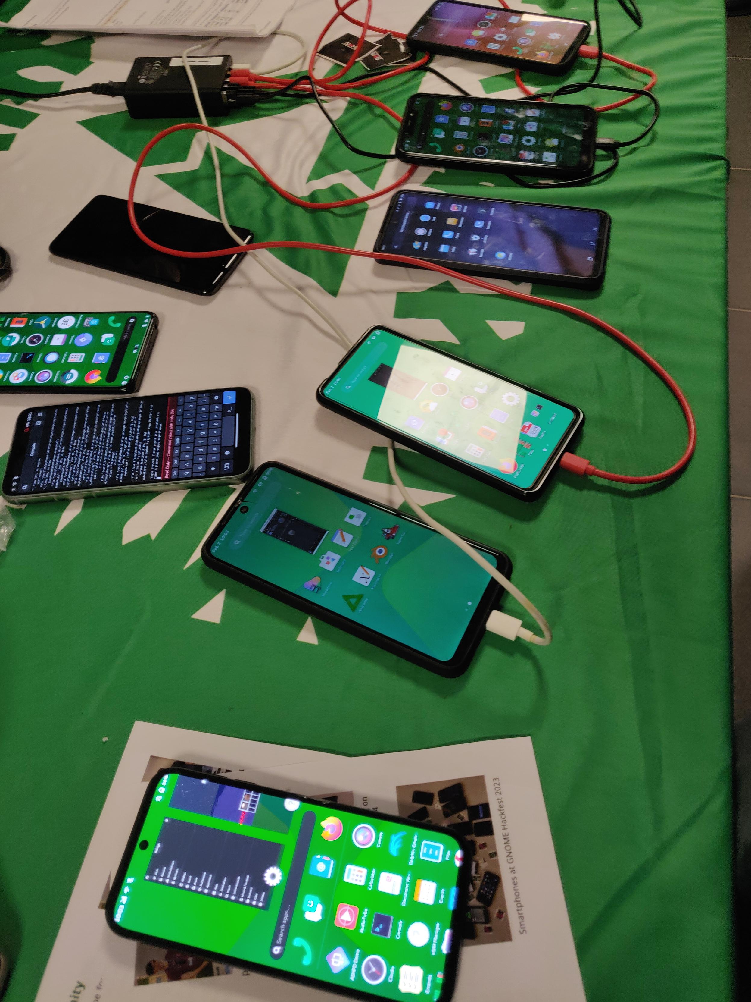 Several phones running PostmarketOS, including a Fairphone5 with phosh